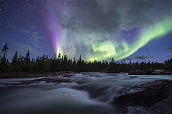 Northern Lights or Aurora Borealis over River Gamajahka or Kamajakka