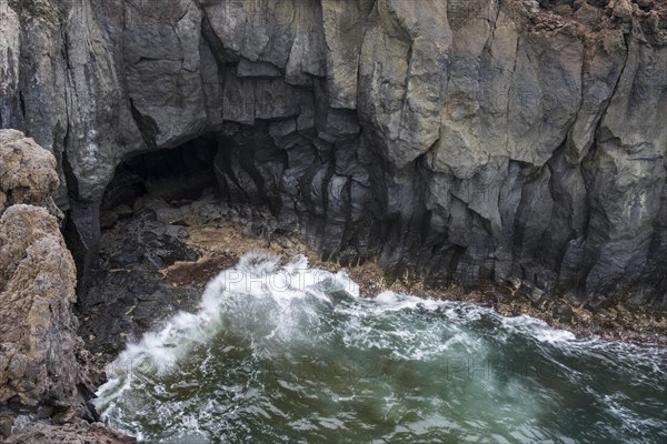 Cave near rocky lava coast