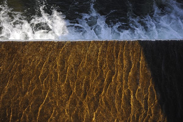 Bubbling water at the edge of a weir