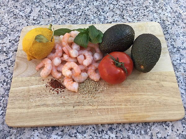 Wooden board with avocados