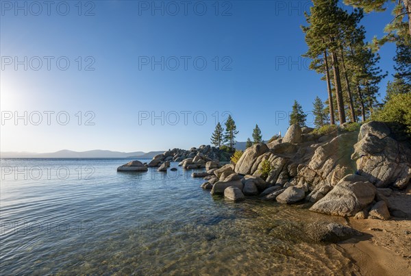 Sand beach and round stones in the water