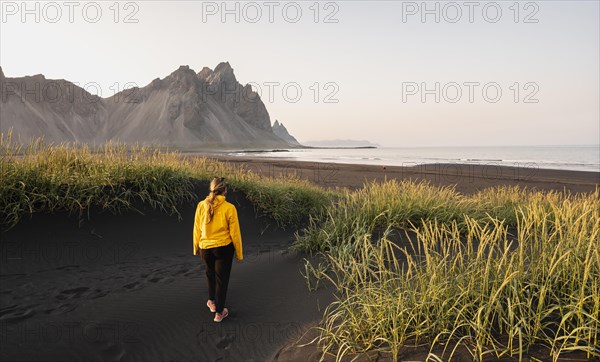 Young woman with rain jacket hiking