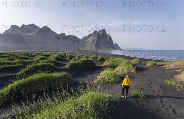 Young woman with rain jacket hiking