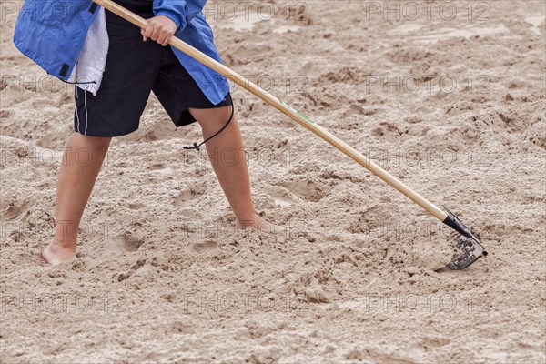 Raking the jumping pit for the long jump