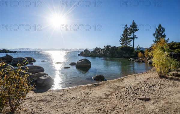 Sand beach and round stones in the water