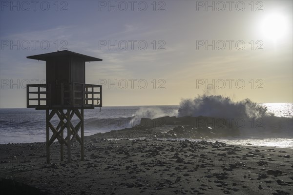 High waves crashing on the beach at a lifeguard lookout