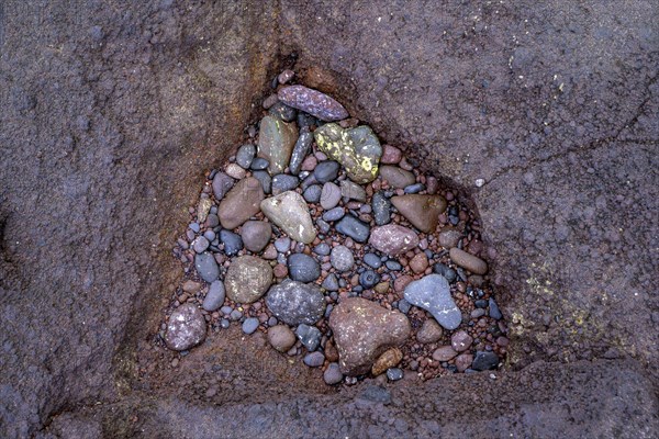 Triangular hollow filled with stones