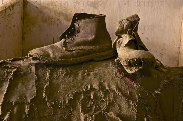 Two work shoes on torn jute bag