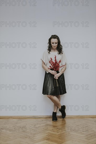 Woman with bouquet of rose hips