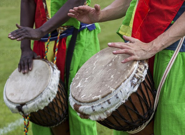 Musicians playing on an African djembe