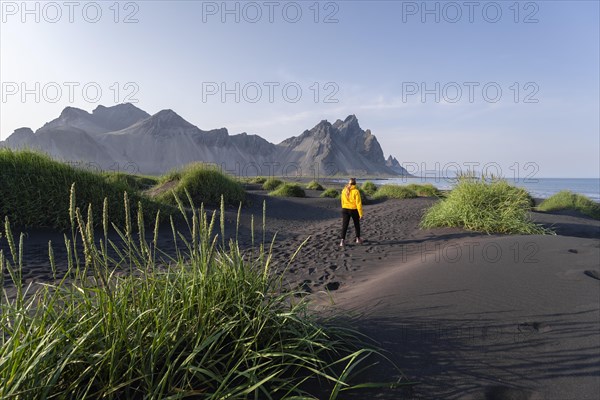 Young woman with rain jacket hiking