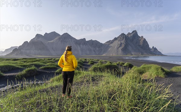 Young woman with rain jacket hiking