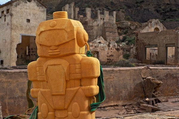 Yellow plastic figure in front of ruins of a mine in Mazarron