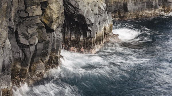 Surf at rocky lava coast