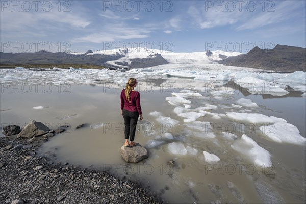 Woman in front of Fjallsarlon ice lagoon