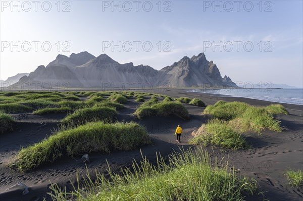 Young woman with rain jacket hiking