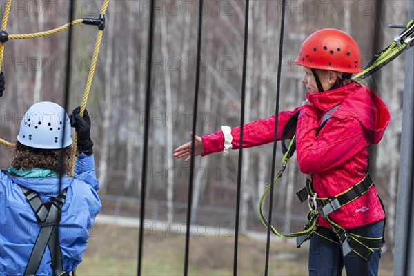 Sporty woman with her niece doing fitness climbing in the outdoor park