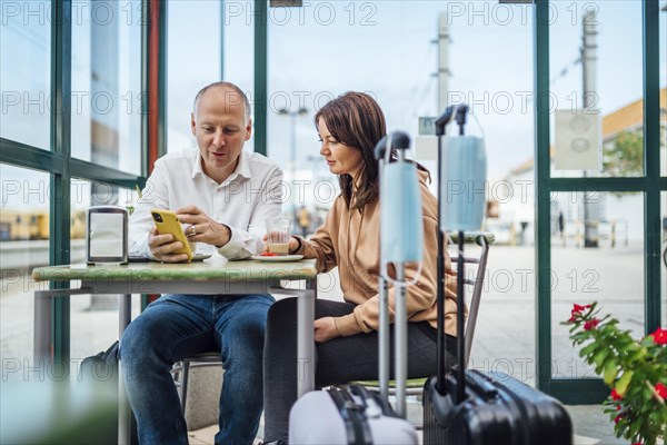 A couple of travelers drinking coffee