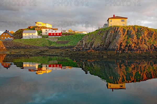 Houses on rocky coast in the last light of day