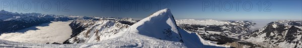 Mountain panorama with high fog over Lake Brienz