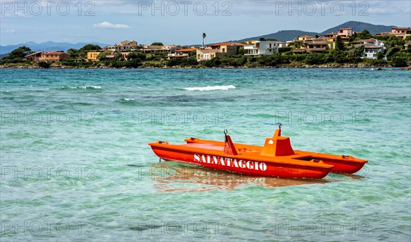 Red lifeboat on the beach of a hotel