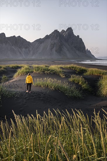 Young woman with rain jacket hiking