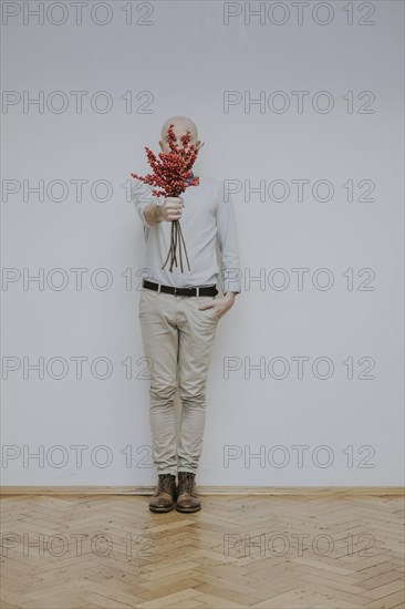 Man with bouquet of rose hips