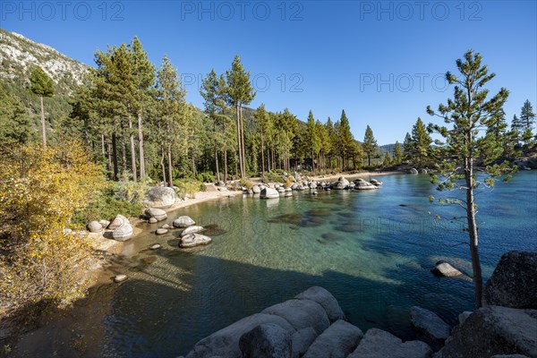 Sand beach and round stones in the water