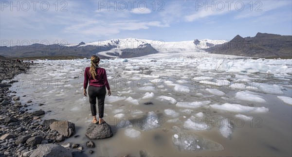 Woman in front of Fjallsarlon ice lagoon
