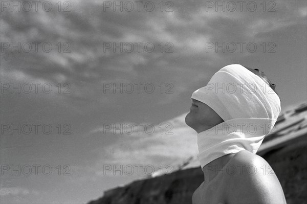 Head painting of woman with bandage