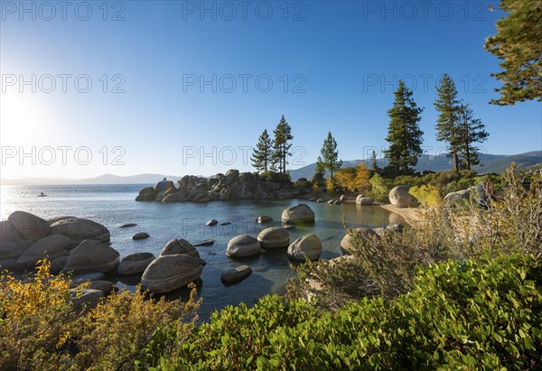 Bay with sandy beach and round stones in the water