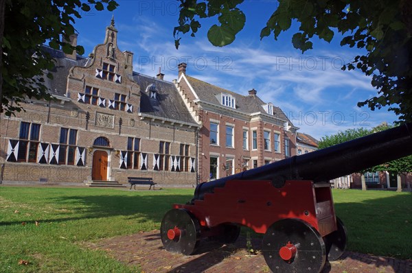 Cannon in front of typical Dutch houses