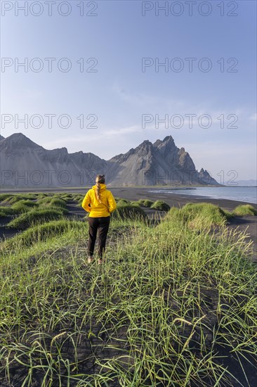 Young woman with rain jacket hiking