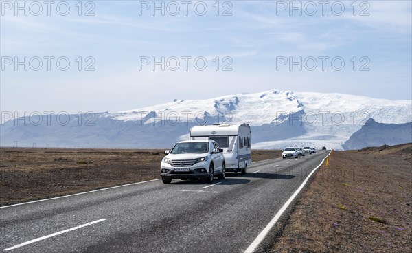 Car with caravan trailer on country road