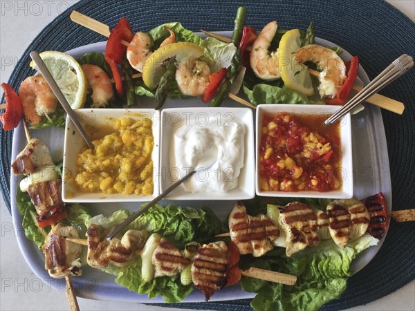 Salad plate with dip bowls Prawn skewers