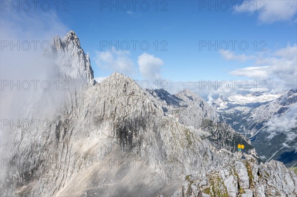 Two hikers in front of alpine panorama