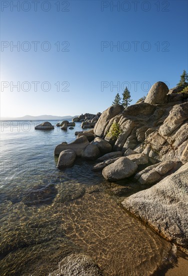 Sand beach and round stones in the water