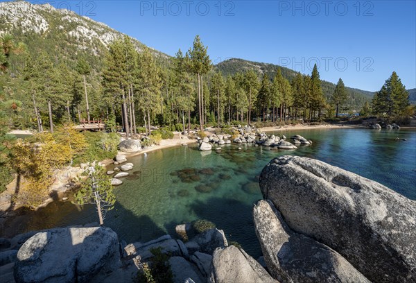 Sand beach and round stones in the water