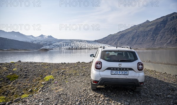 Car standing in front of glacier