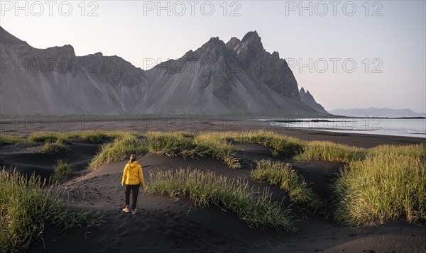 Young woman with rain jacket hiking