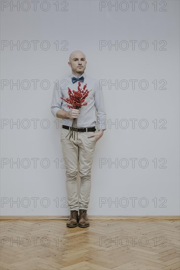 Man with bouquet of rose hips