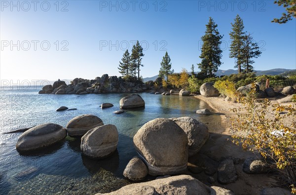 Sand beach and round stones in the water