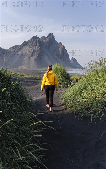 Young woman with rain jacket hiking