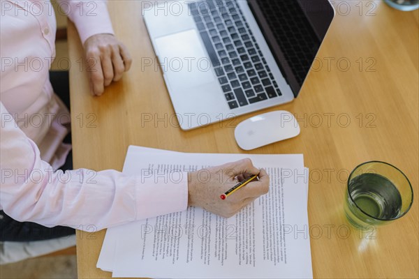 Woman proofreading at her desk