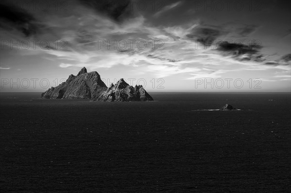 Two rocky islands in the sea at sunset