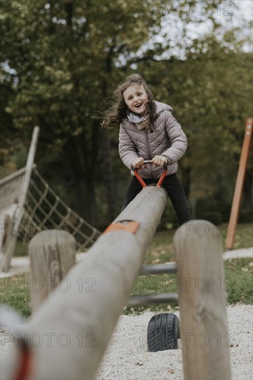 Girl on a seesaw