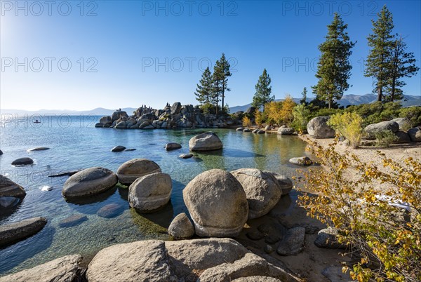 Sand beach and round stones in the water