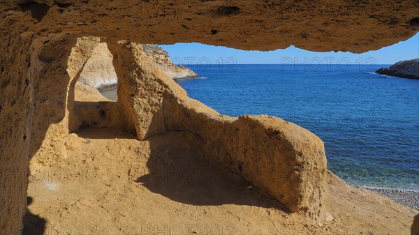 Bay with rock caves in the sandstone at Cabo Cope