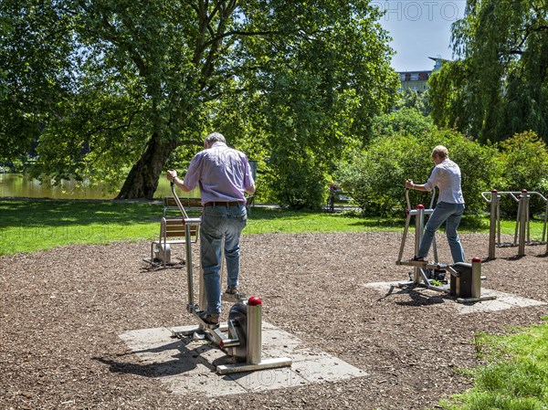 Seniors exercising on outdoor fitness equipment at Lietzensee Park