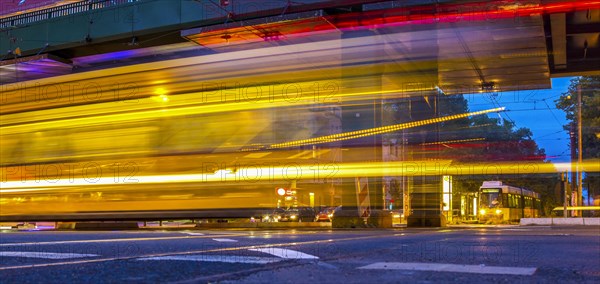 Moving trams at an intersection with a speed camera column